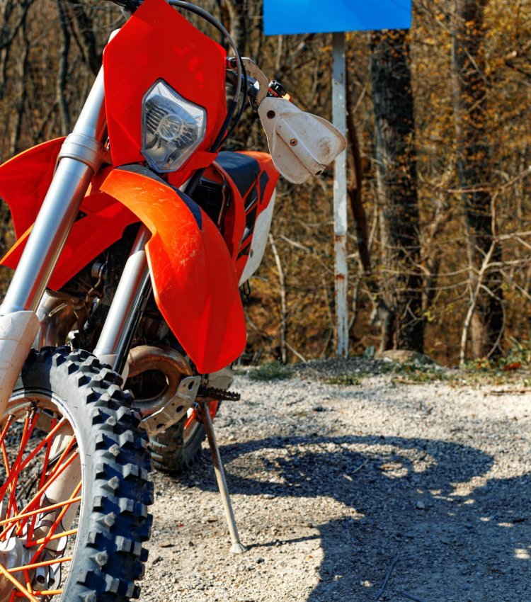 Close-up photo details of cross motorcycle parked on ground